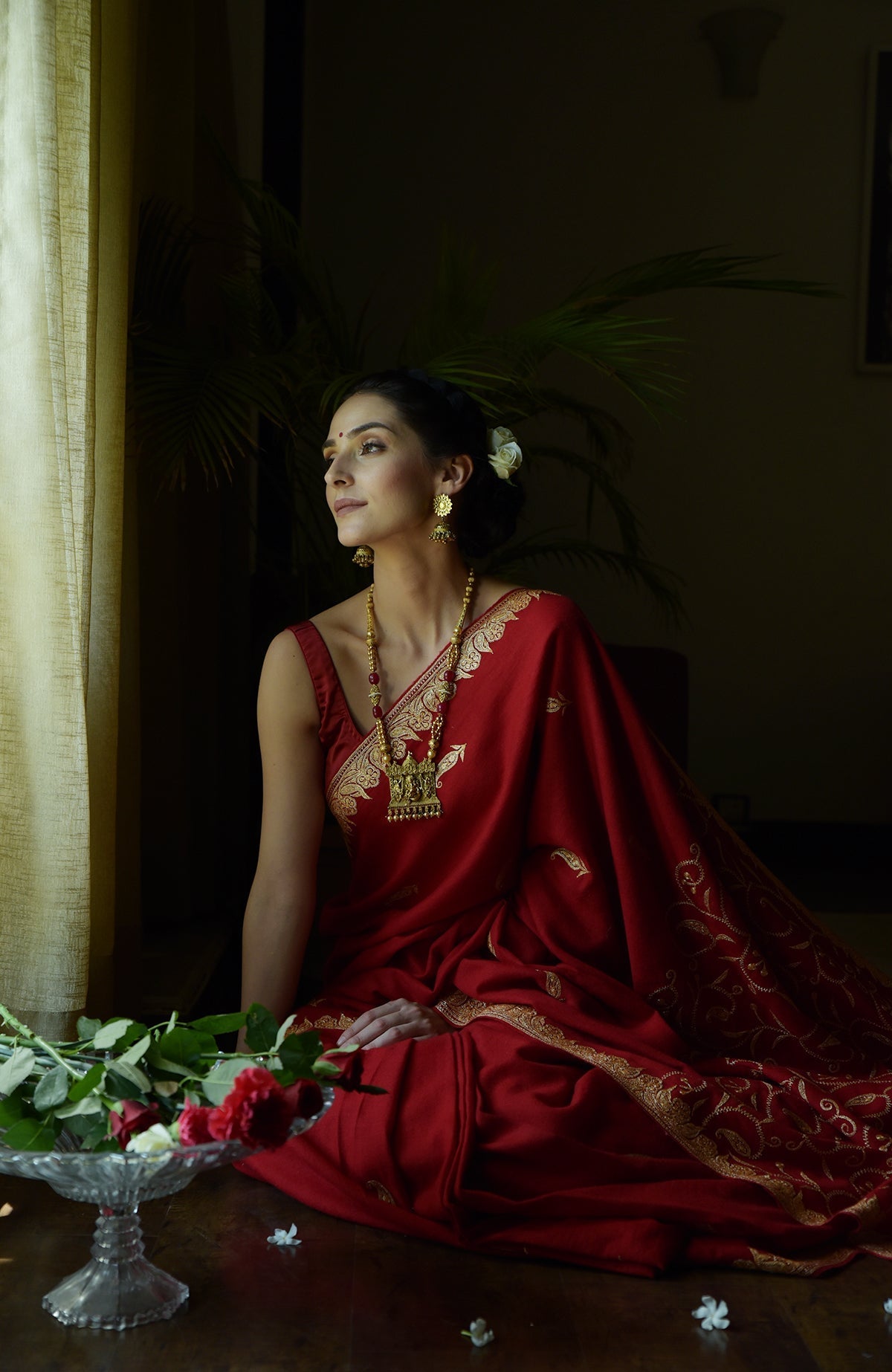 Red pure crepe saree with gold Kashmiri tilla embroidery and paisley bootis on pallav and blouse.