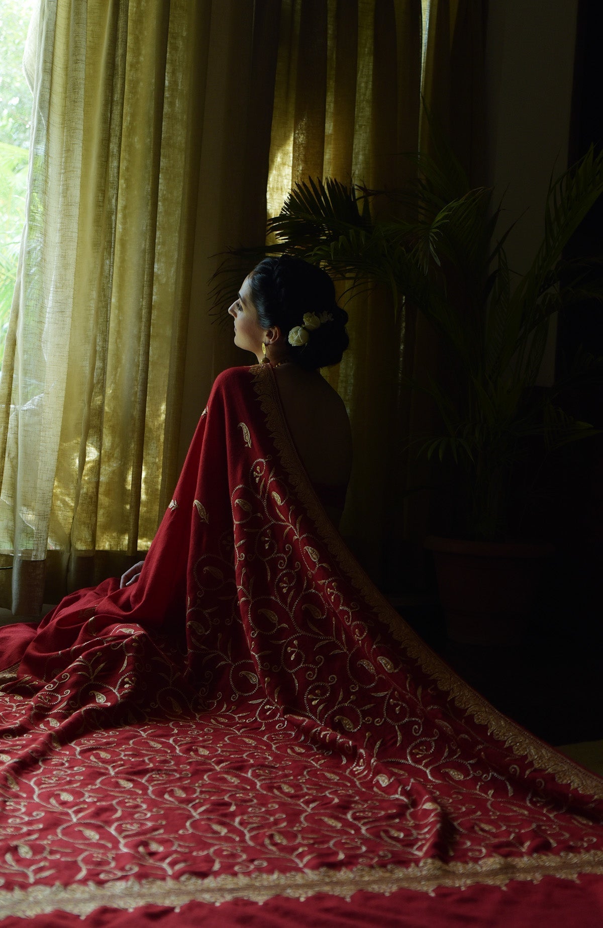 Red pure crepe saree with gold Kashmiri tilla embroidery and paisley bootis on pallav and blouse.