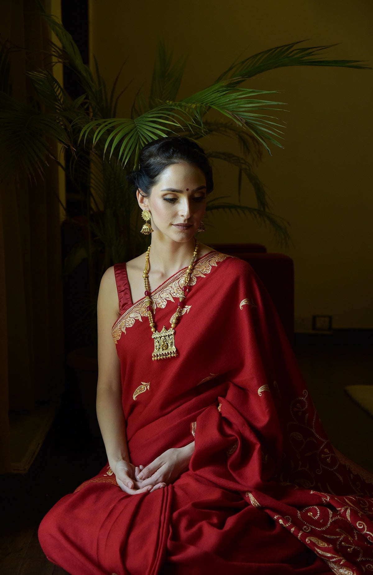 Red pure crepe saree with gold Kashmiri tilla embroidery and paisley bootis on pallav and blouse.