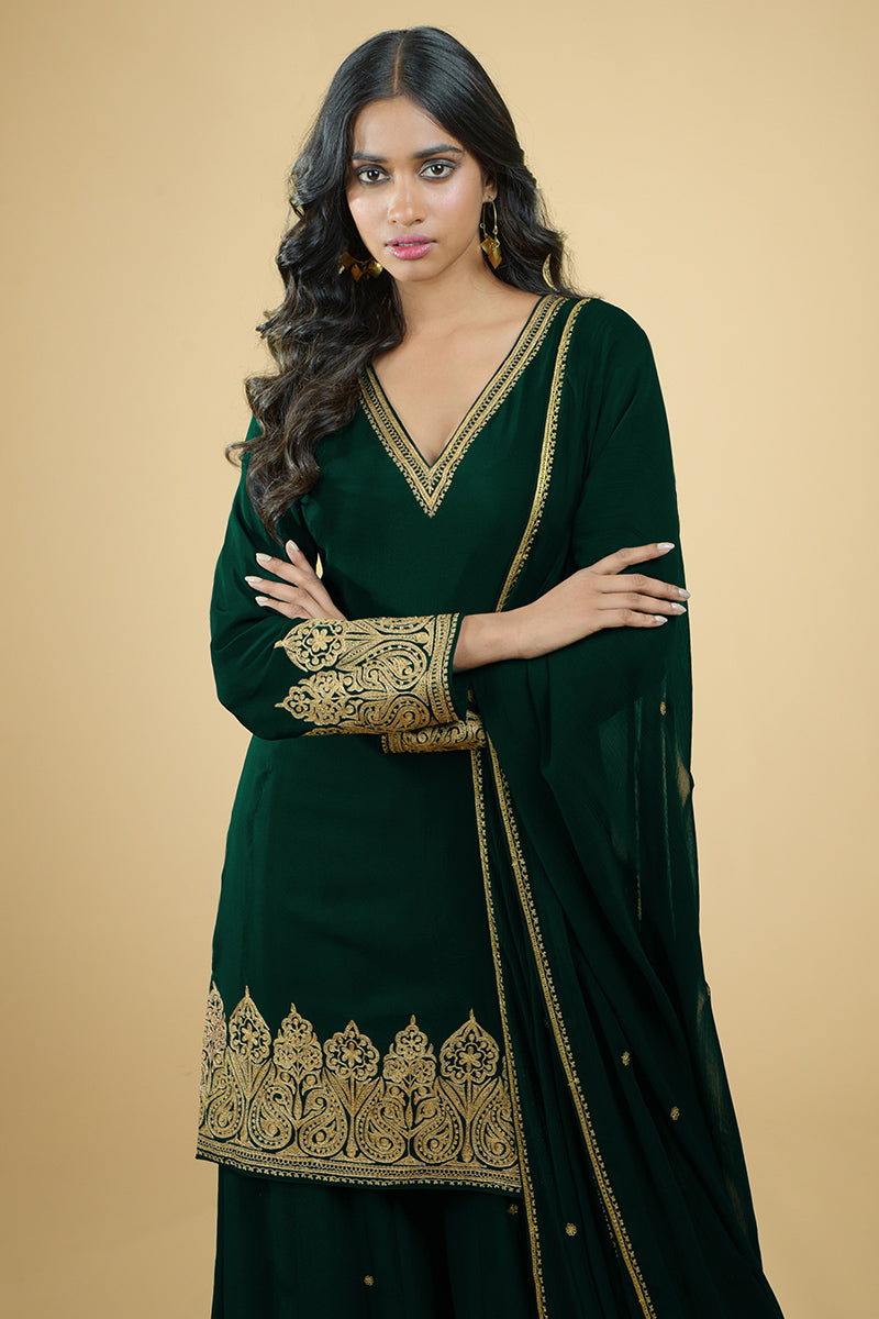 Emerald green crepe sharara set with gold Kashmiri Tilla Aari embroidery and chiffon dupatta.