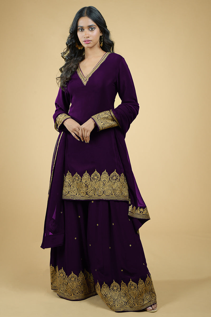 Black sharara set with gold Kashmiri tilla aari floral and paisley embroidery details.