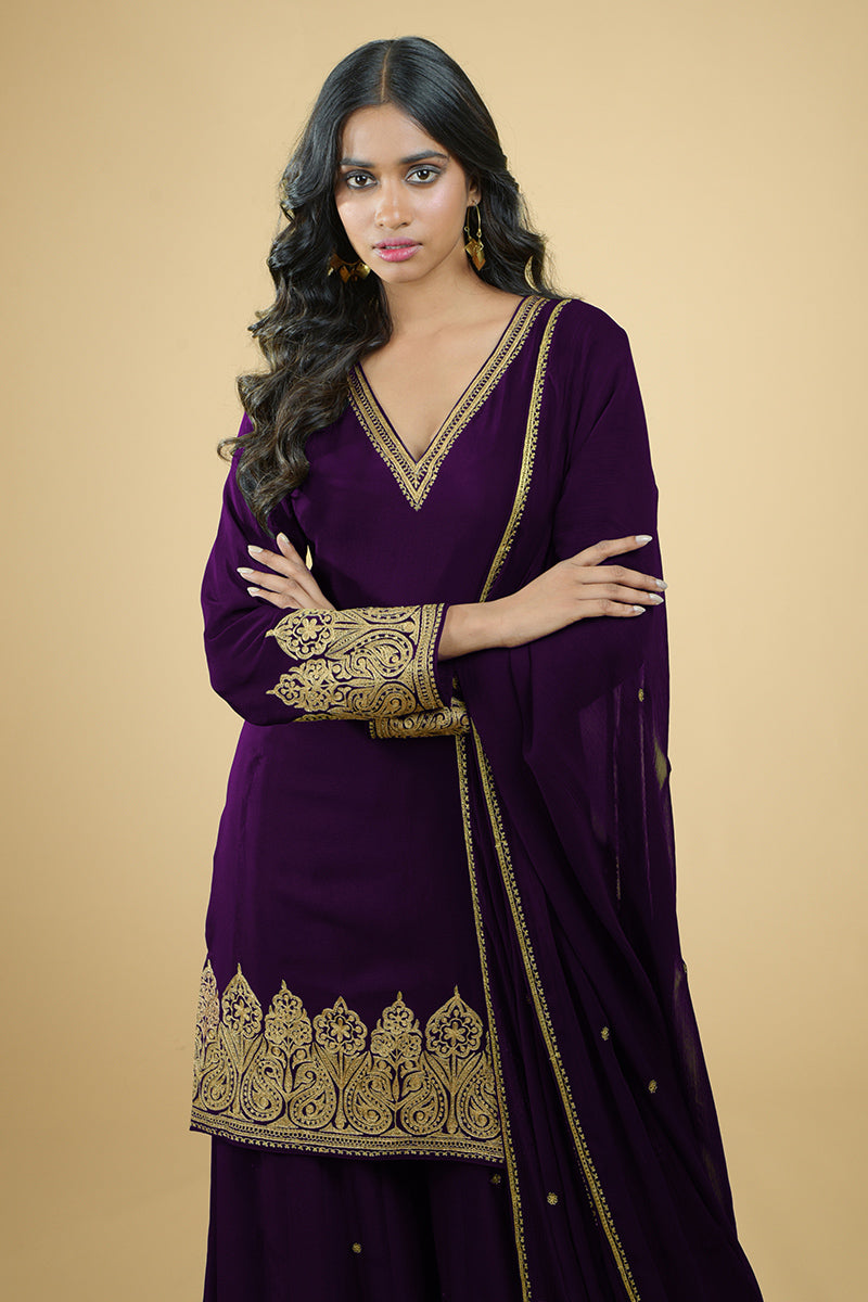 Plum crepe sharara set with gold Kashmiri tilla aari embroidery and chiffon dupatta.