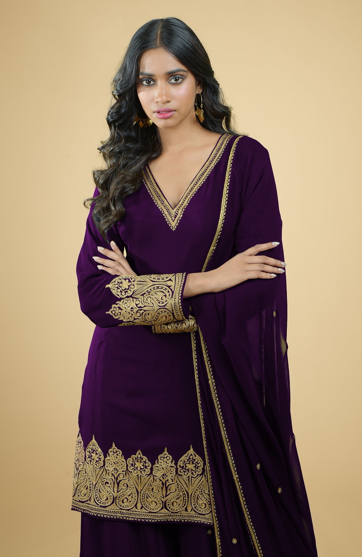 Plum crepe sharara set with gold Kashmiri tilla aari embroidery and chiffon dupatta.