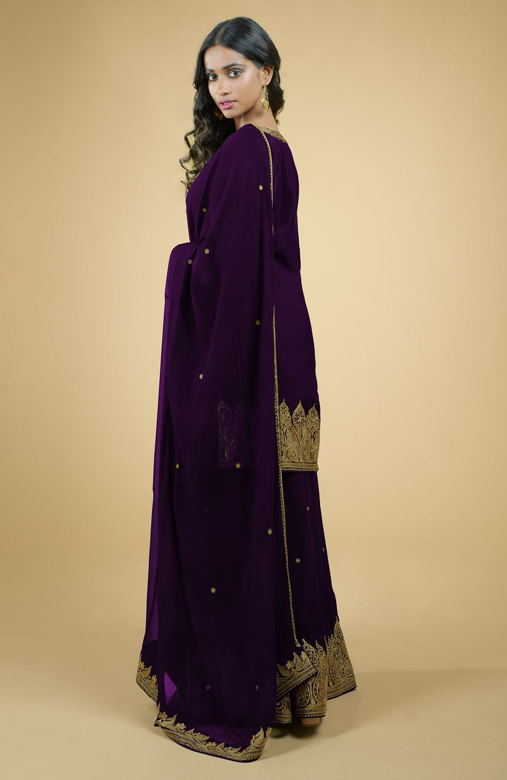 Plum crepe sharara set with gold Kashmiri tilla aari embroidery and chiffon dupatta.