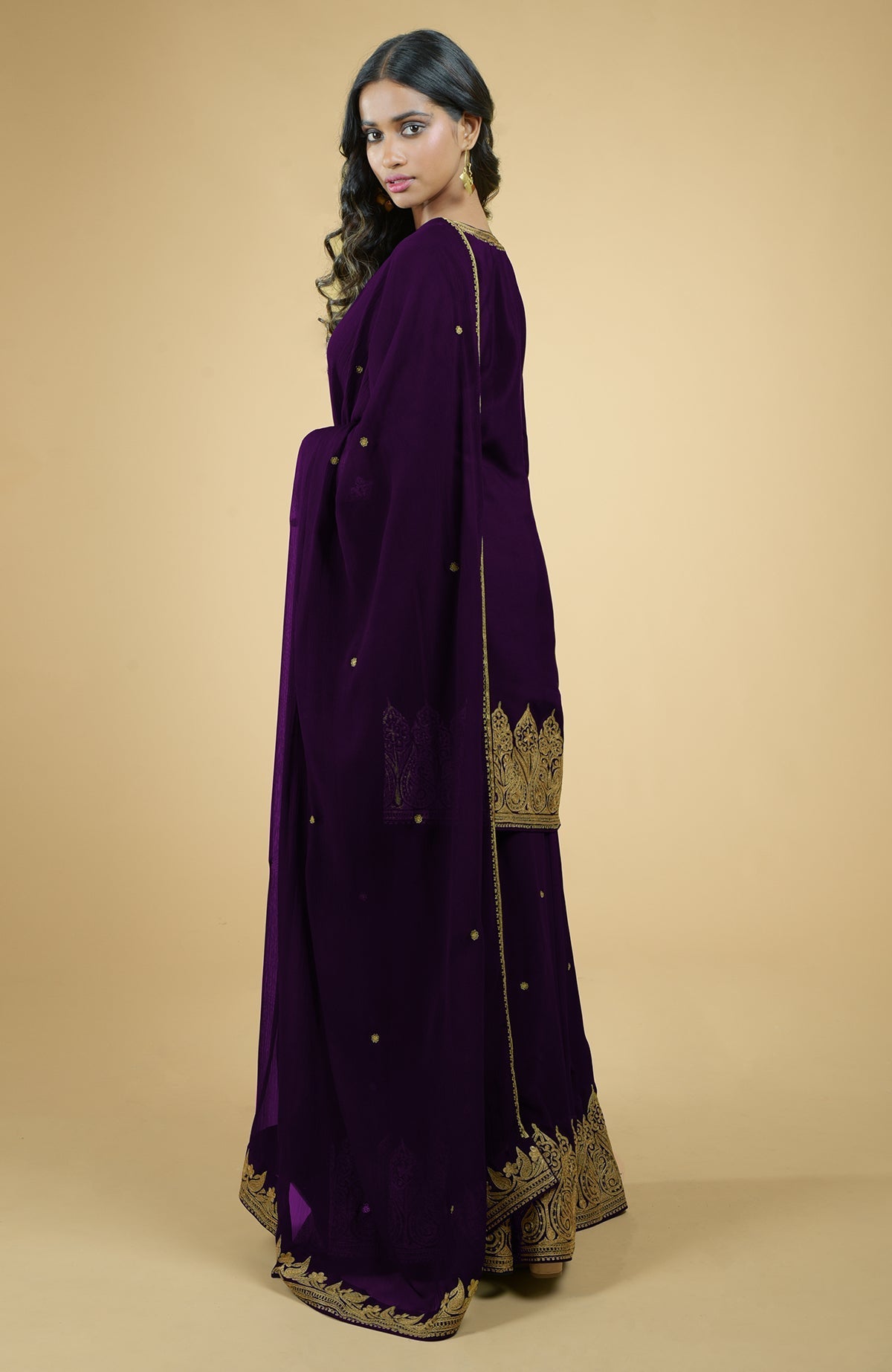 Plum crepe sharara set with gold Kashmiri tilla aari embroidery and chiffon dupatta.