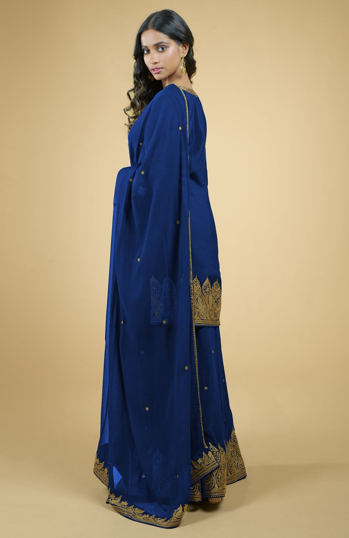 Cobalt blue crepe sharara set with gold Kashmiri tilla aari embroidery and chiffon dupatta.