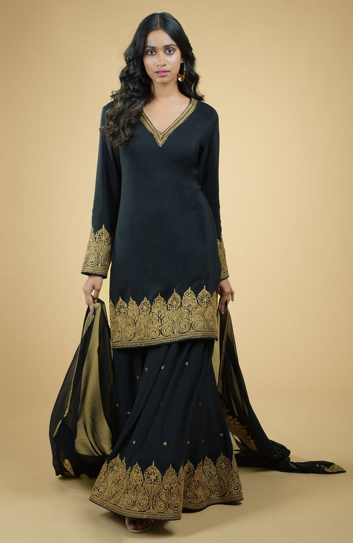Black sharara set with gold Kashmiri tilla aari floral and paisley embroidery on kurta and dupatta