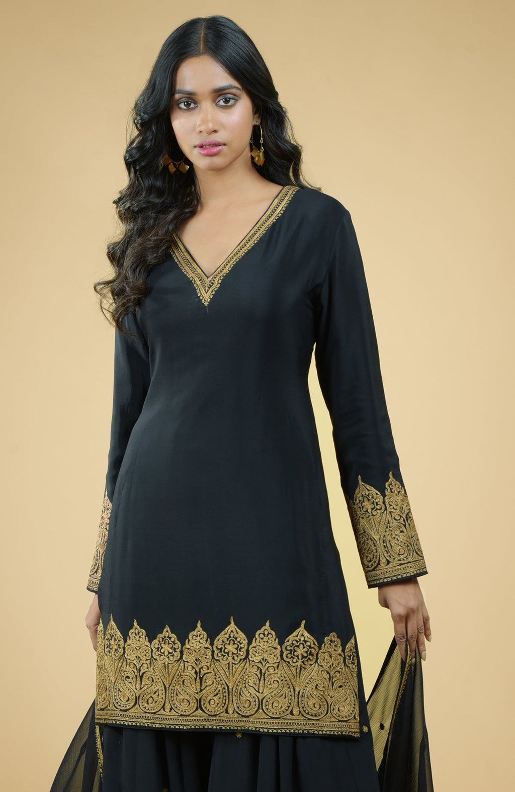 Black sharara set with gold Kashmiri Tilla Aari floral and paisley embroidery and chiffon dupatta.