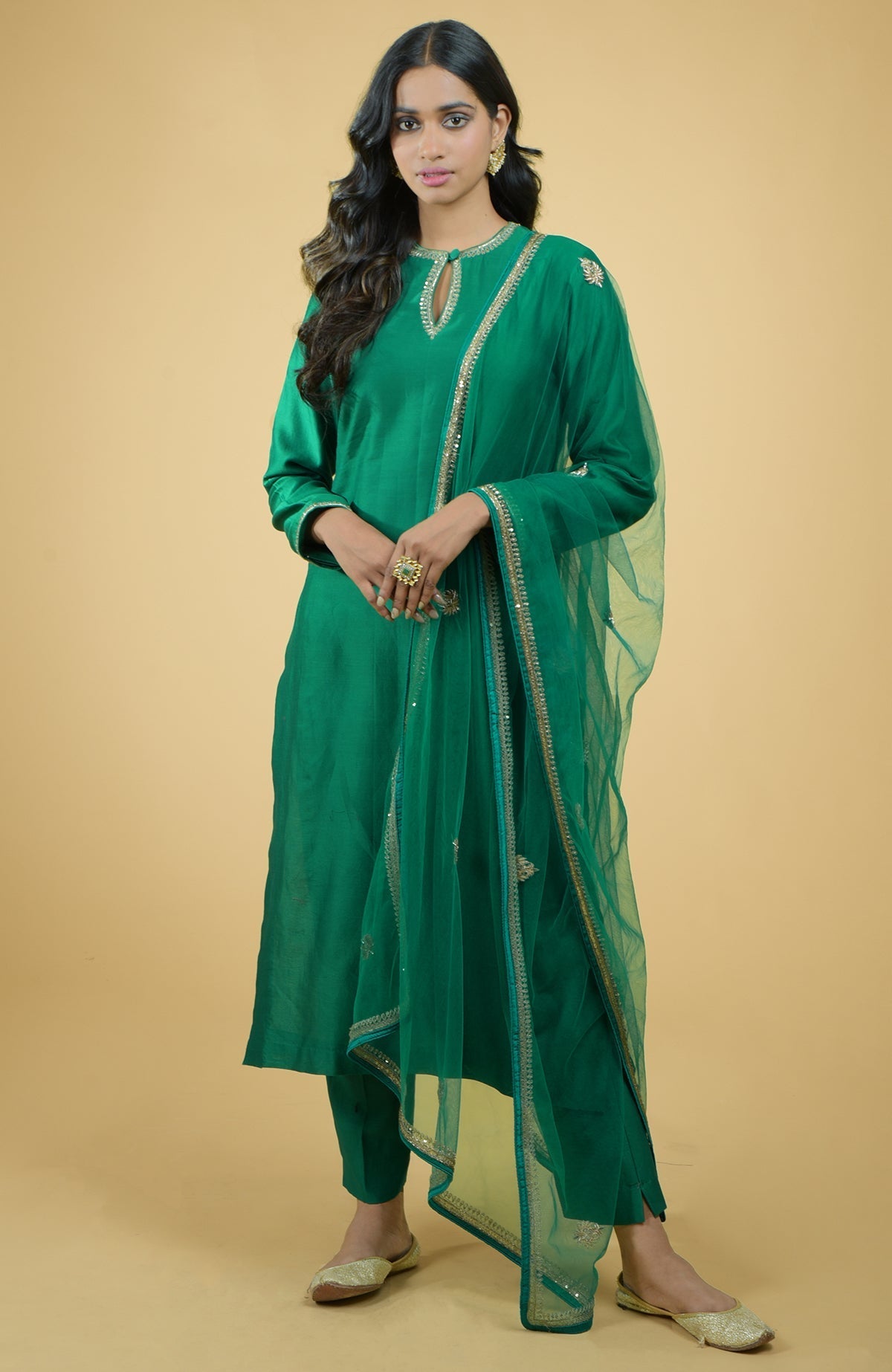 Emerald green kurta set with gold hand-embroidered zardozi floral work and matching pants