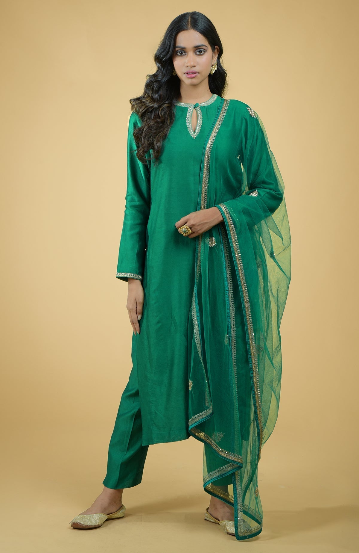 Emerald green kurta set with gold hand-embroidered zardozi floral work and matching pants