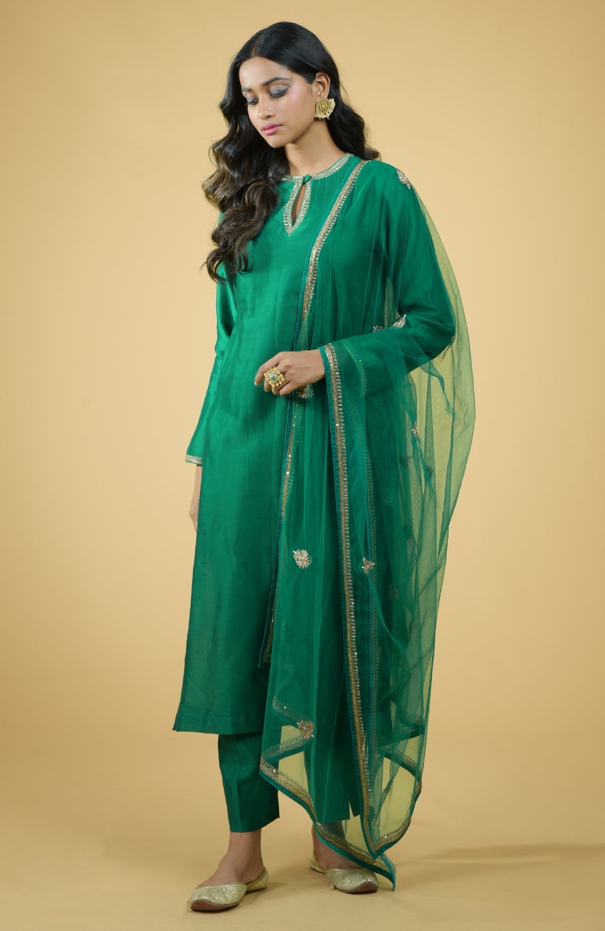 Emerald green kurta set with gold hand-embroidered zardozi floral work and matching pants
