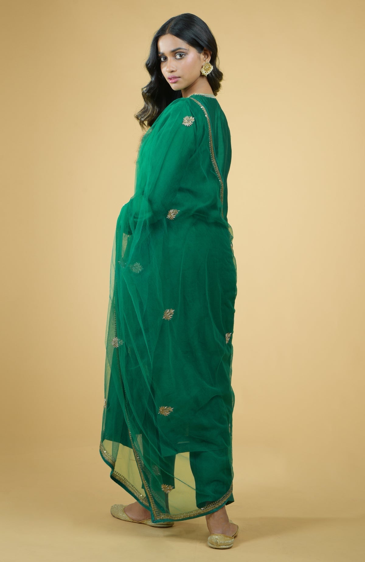 Emerald green kurta set with gold hand-embroidered zardozi floral work and matching pants