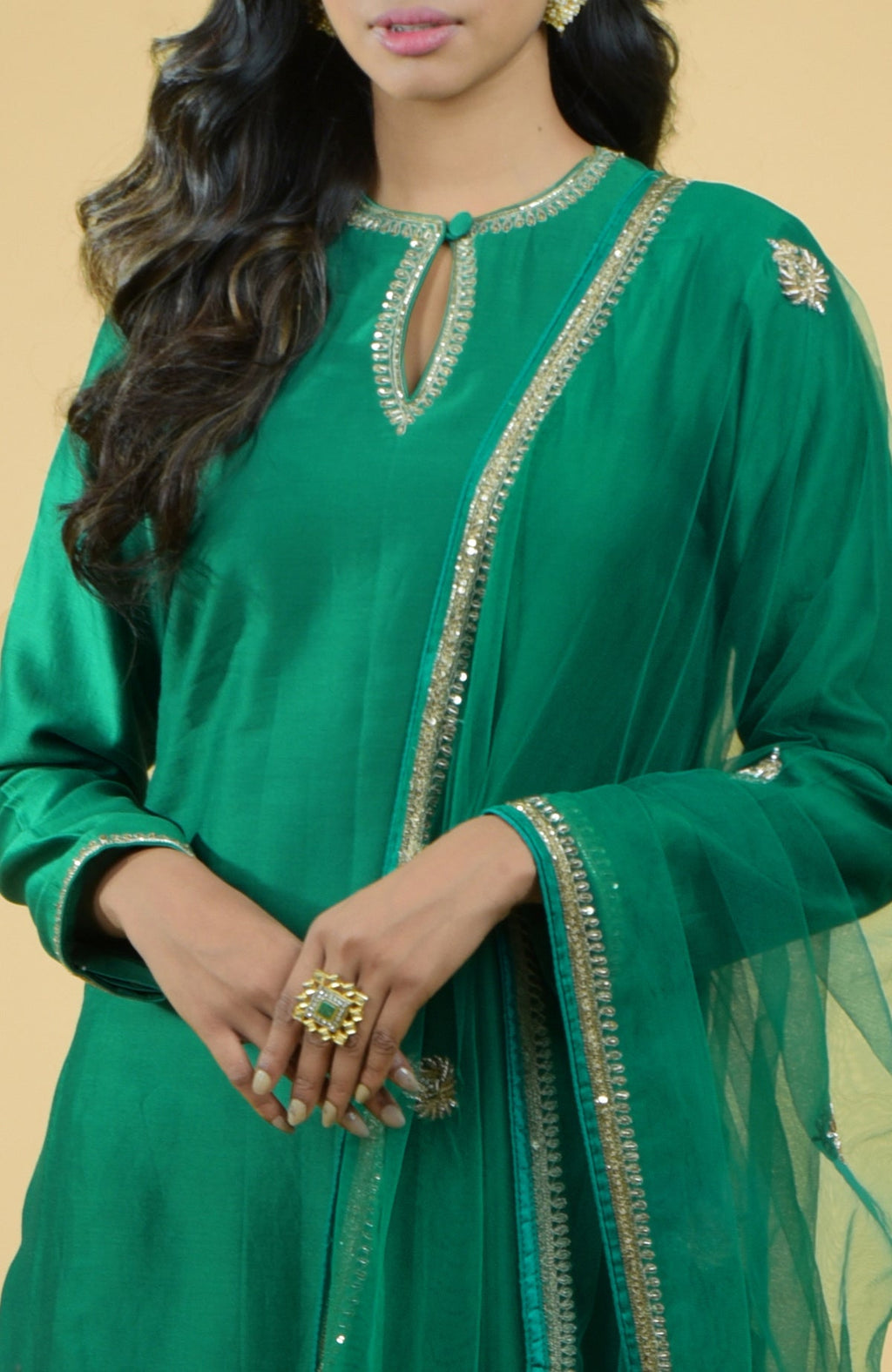 Emerald green kurta set with gold hand-embroidered zardozi floral work and matching pants