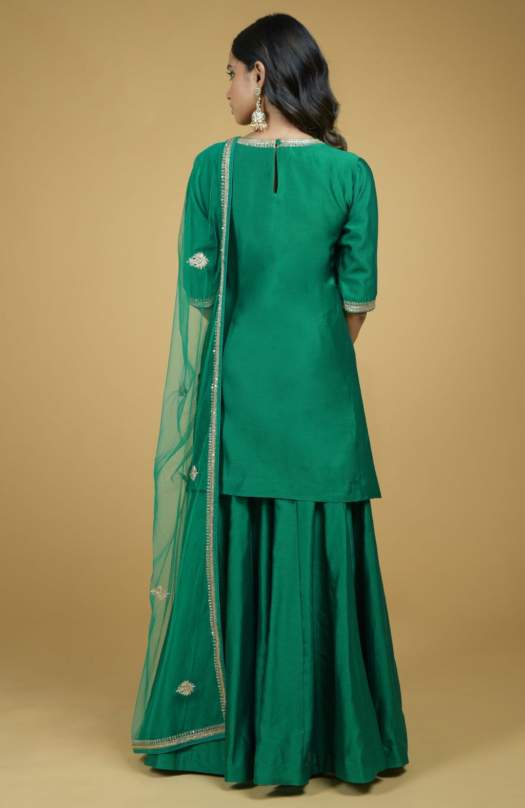 Emerald green kurta set with gold hand-embroidered zardozi floral work and matching pants