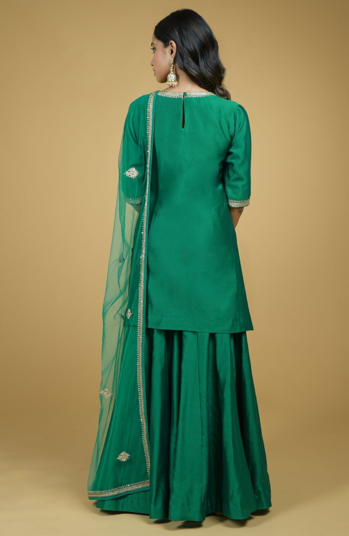 Emerald green kurta set with gold hand-embroidered zardozi floral work and matching pants