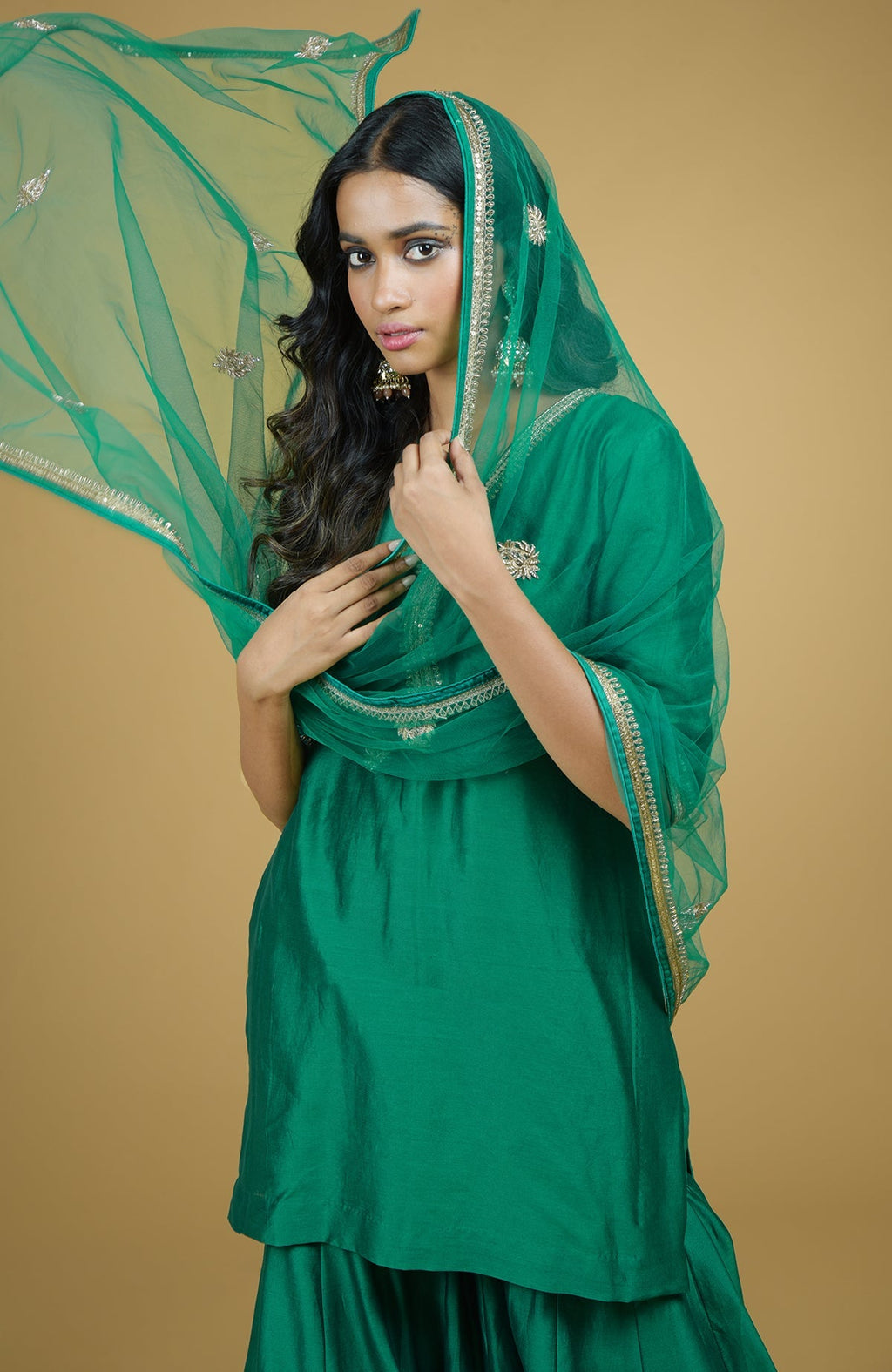 Emerald green Gharara set with hand-embroidered gold zardozi floral work on silk fabric.