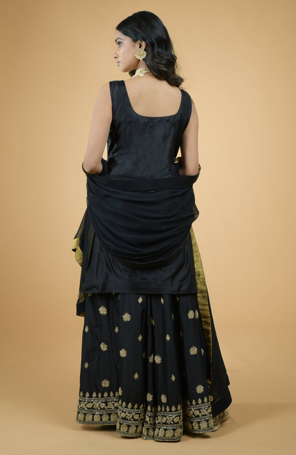 Black silk sharara set with gold zardozi dabka floral embroidery and flowy georgette dupatta