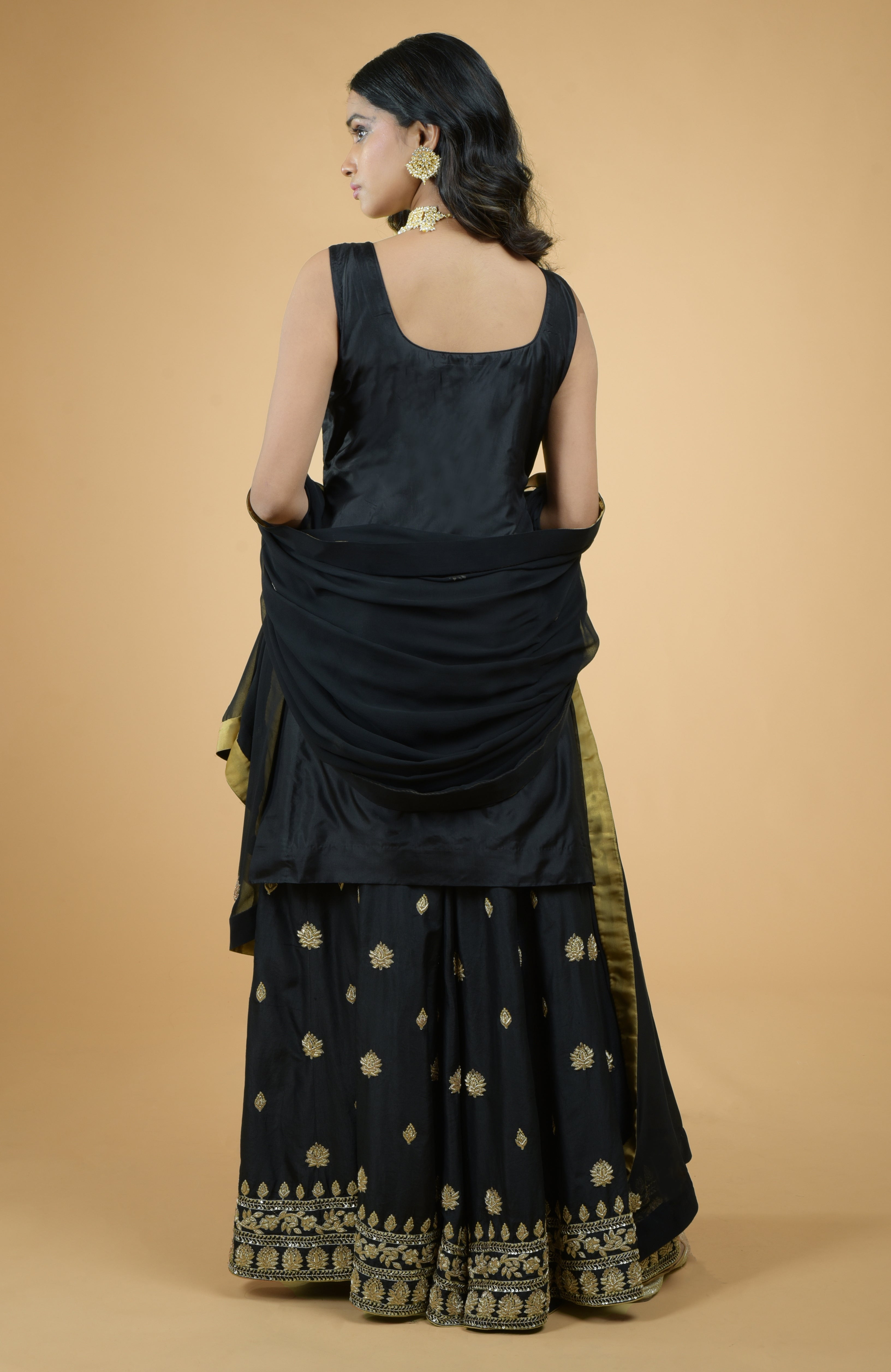 Black silk sharara set with gold zardozi dabka floral embroidery and flowy georgette dupatta