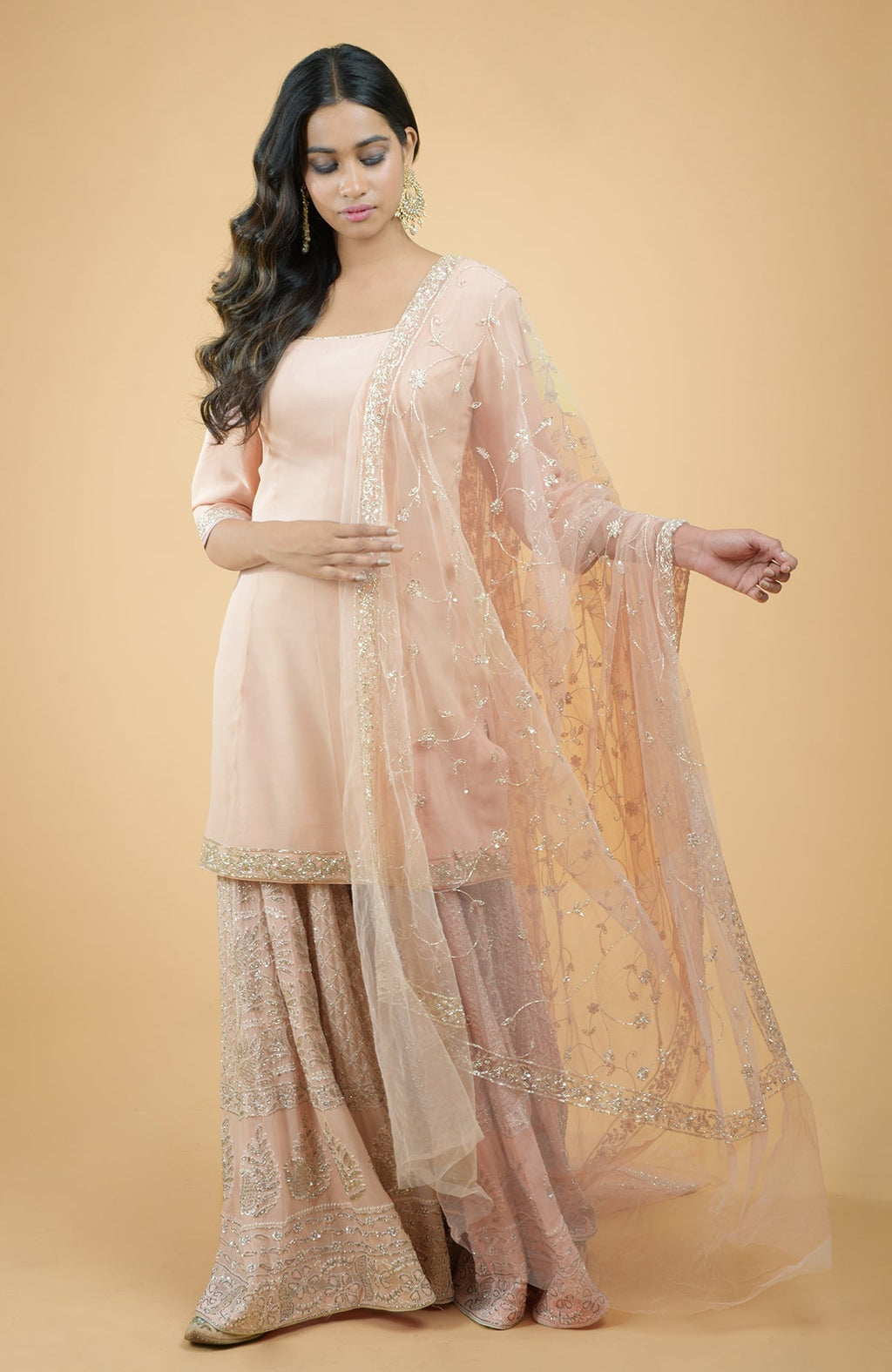 Nude pink georgette sharara set with hand-embroidered chikankari, beads, and sequin zardozi details.