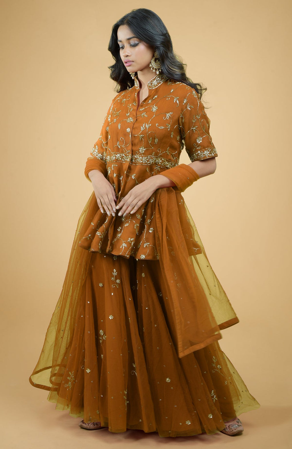 Scarlet red sharara set with gold bead and sequin zardozi embroidery and sheer organza peplum top.