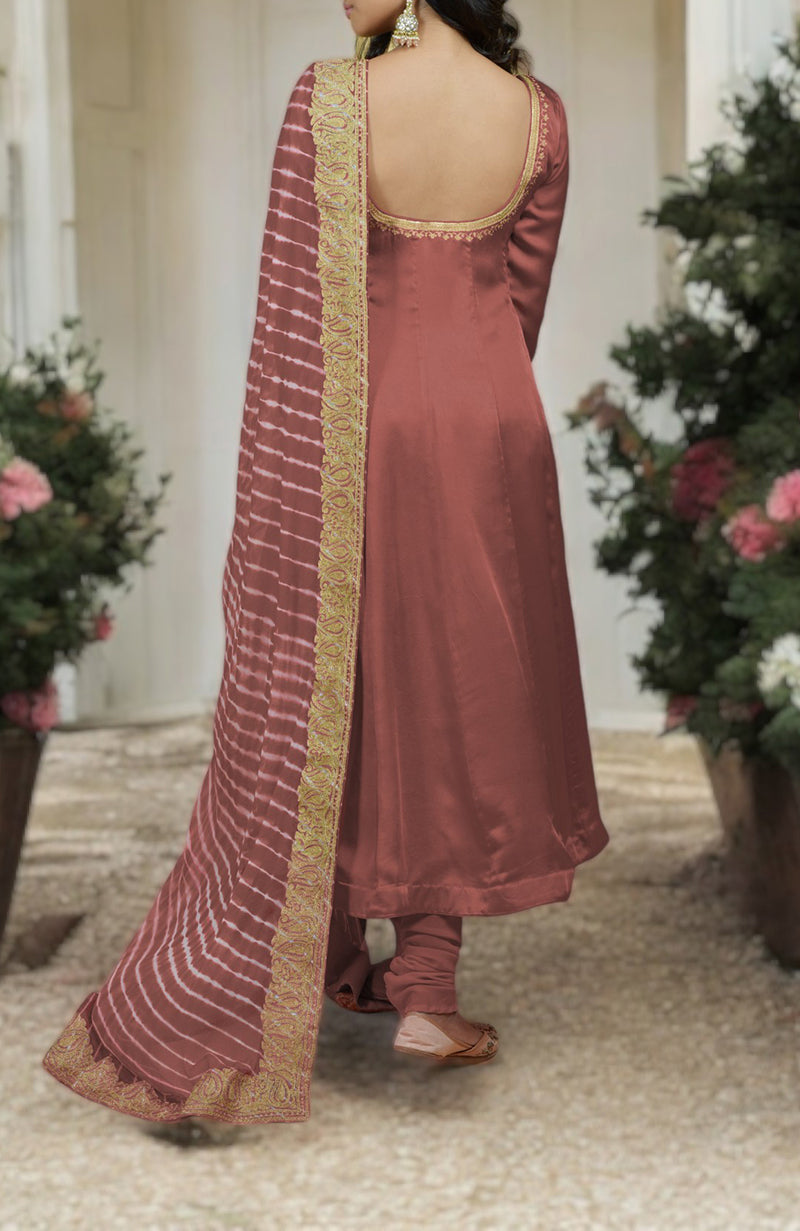 A woman from behind wears a chutney-colored Anarkali suit with a leheriya-tilla embroidered dupatta.