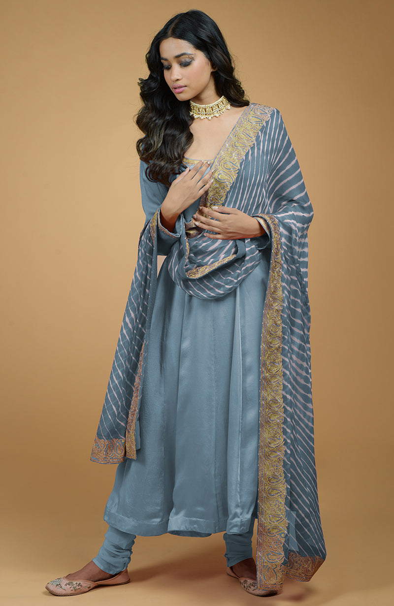 Coral orange leheriya dupatta with gold tilla embroidery paired with peach Anarkali set.
