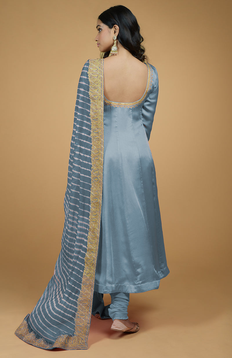 A woman models a greyish-blue Anarkali set with a leheriya-tilla embroidered dupatta.