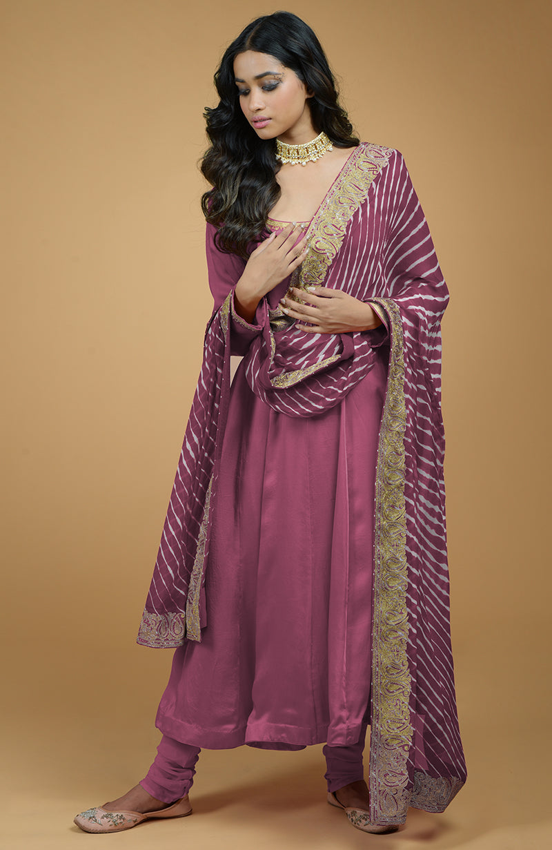 A woman models a greyish blue Anarkali set with a leheriya-tilla embroidered dupatta.