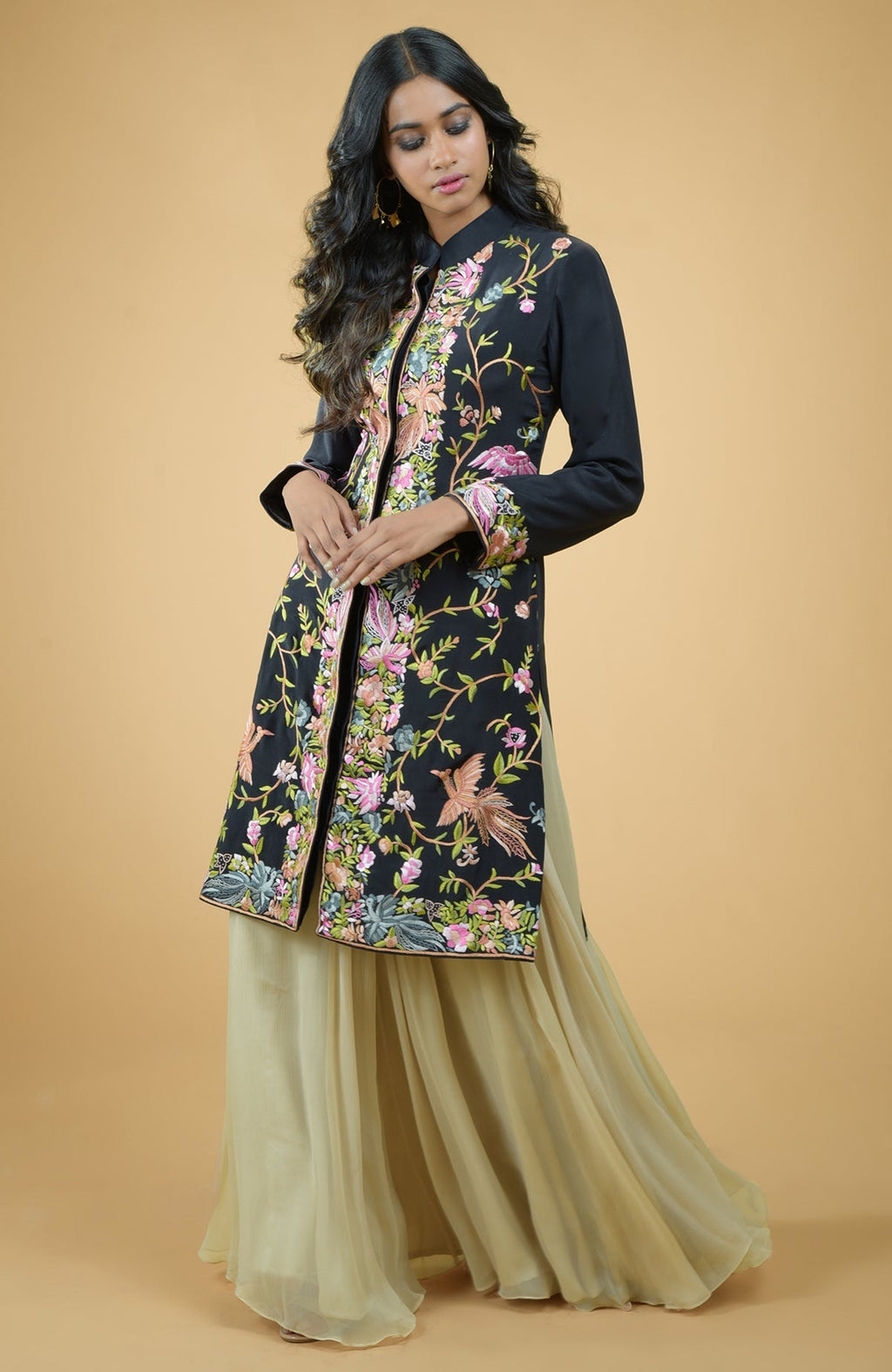 Black Parsi Gara embroidered crepe jacket with multicolor floral and bird designs, paired with gold skirt