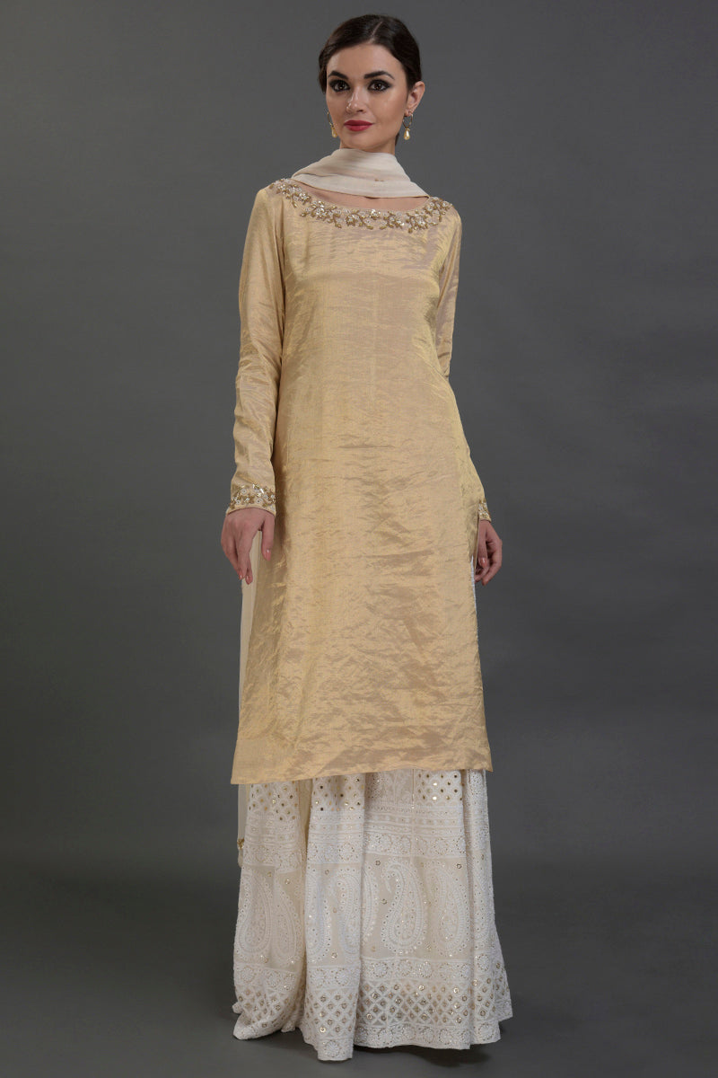 Ivory-gold silk tissue kurta with chikankari sharara and georgette dupatta with gold embroidery.