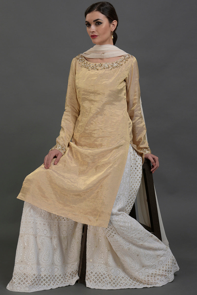 Ivory-gold silk tissue kurta with chikankari sharara and georgette dupatta, hand embroidered.