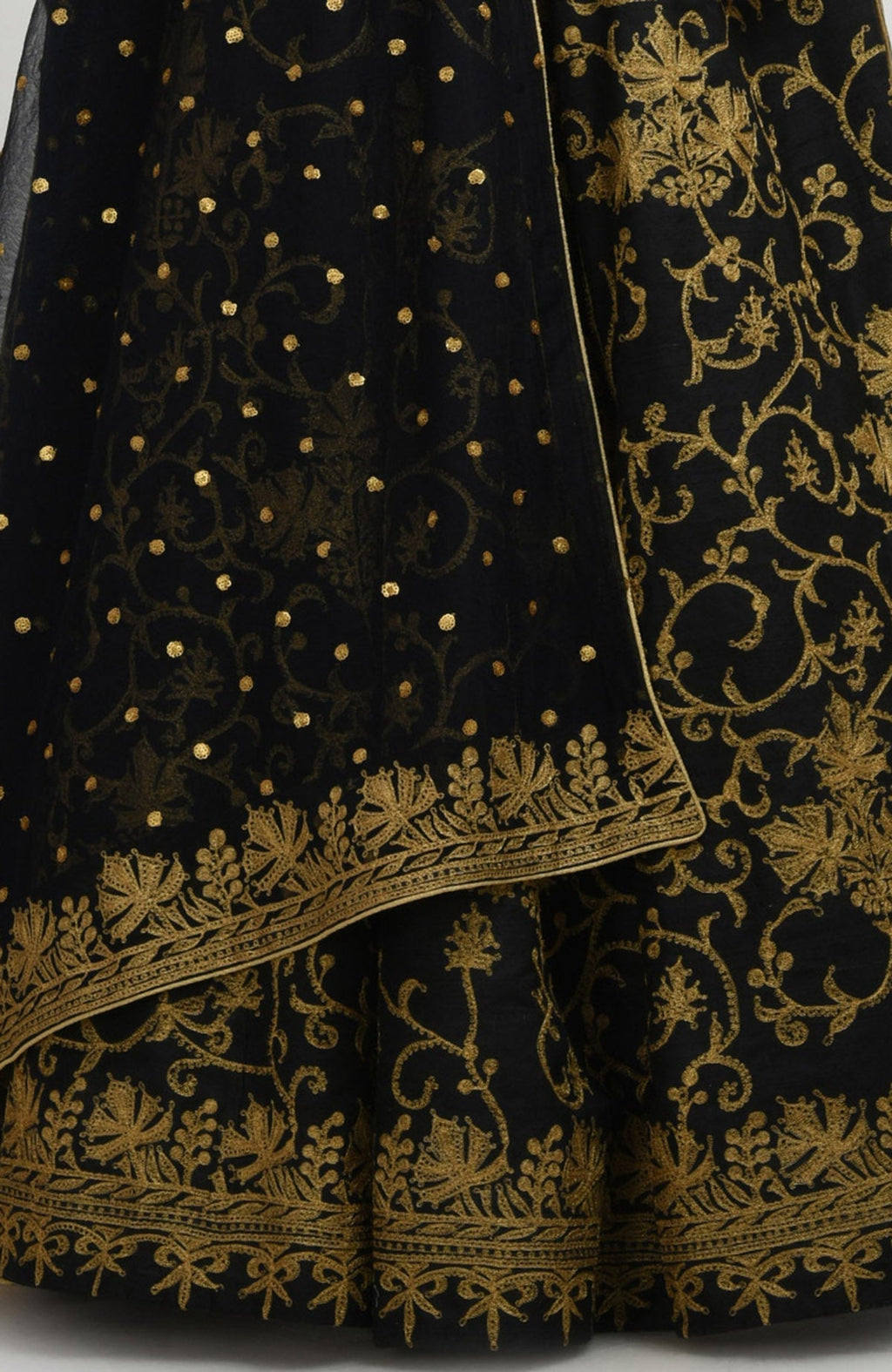 Black raw silk lehenga set with gold Kashmiri tilla aari embroidery and net dupatta with sequins.