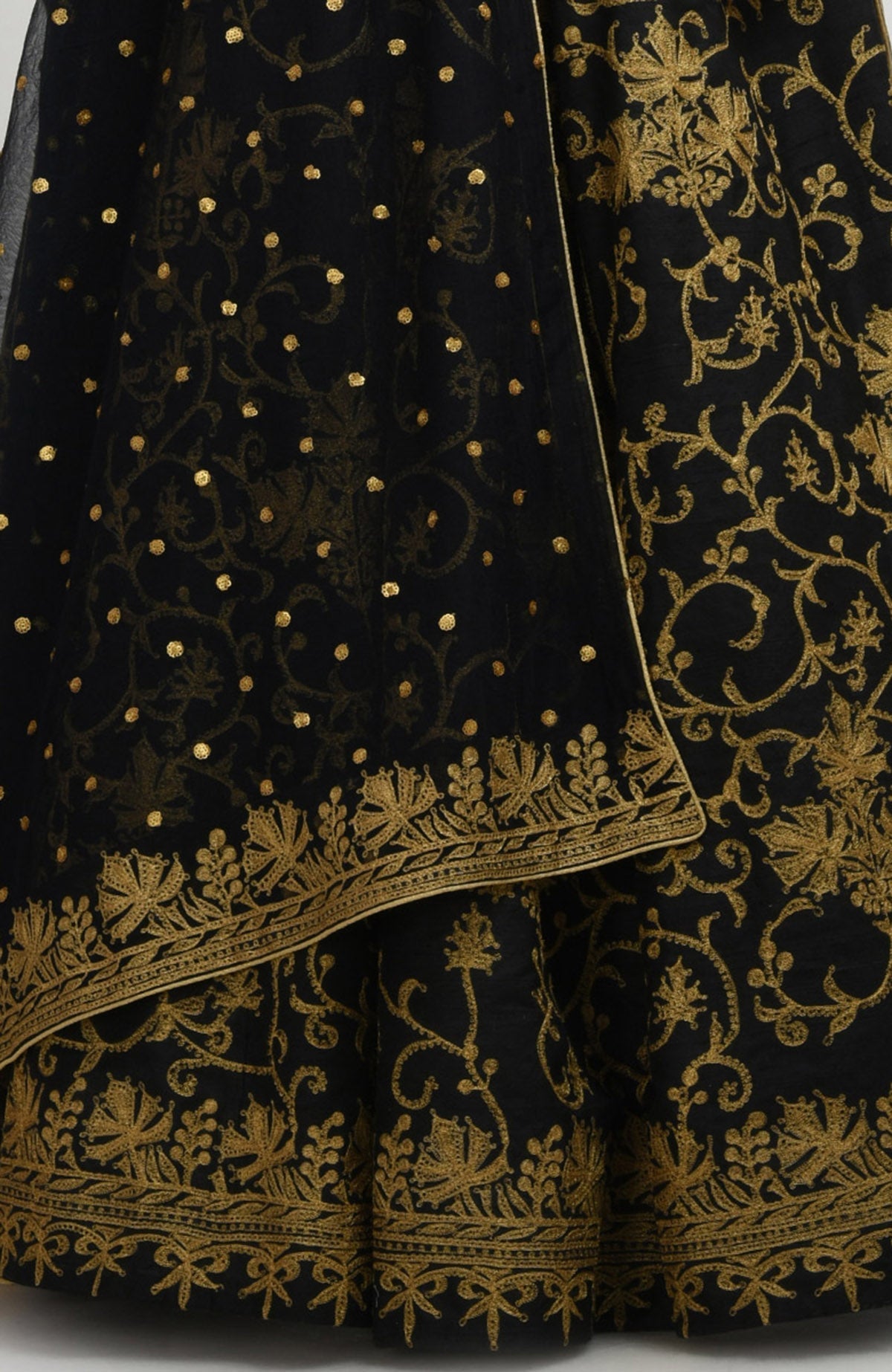 Black raw silk lehenga set with gold Kashmiri tilla aari embroidery and net dupatta with sequins.