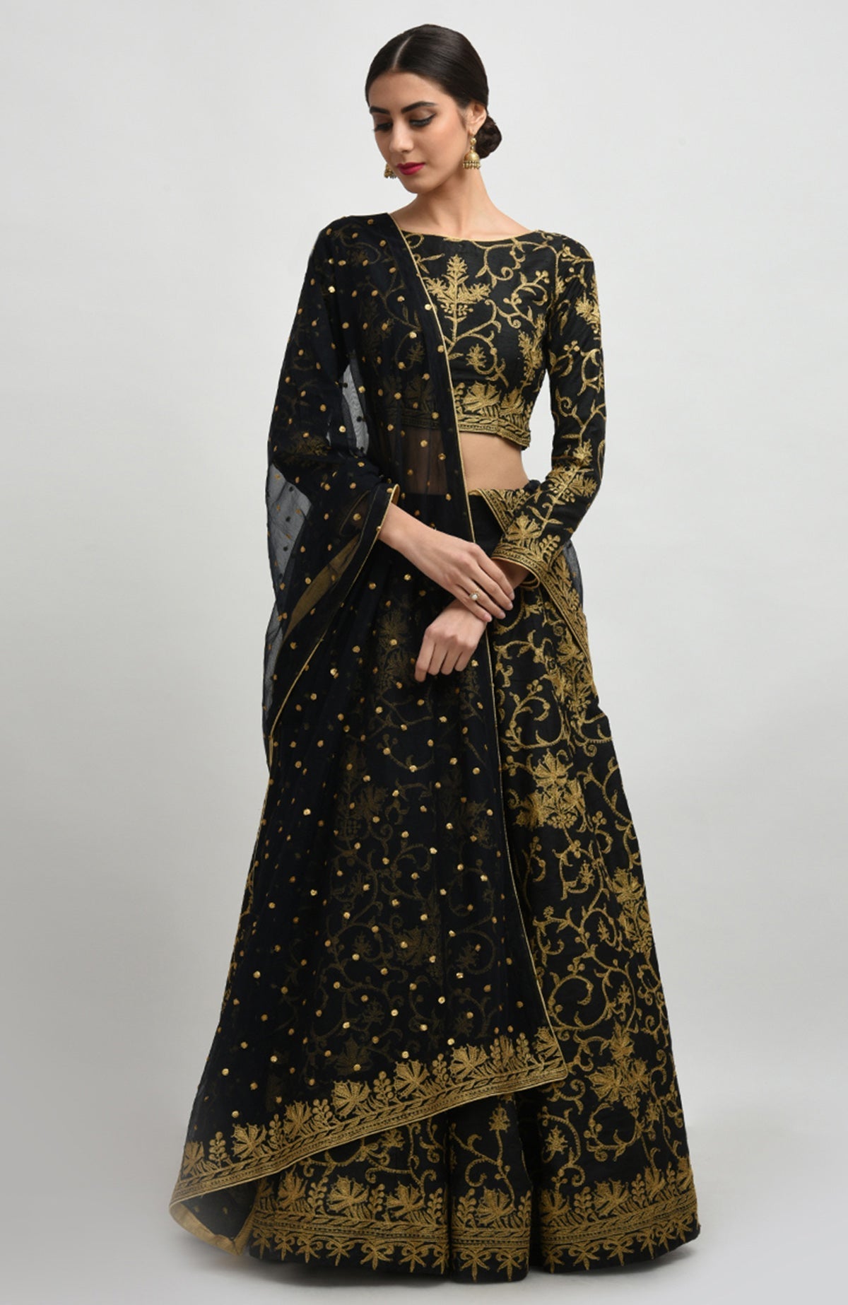 Black raw silk lehenga set with gold Kashmiri tilla aari embroidery and net dupatta.