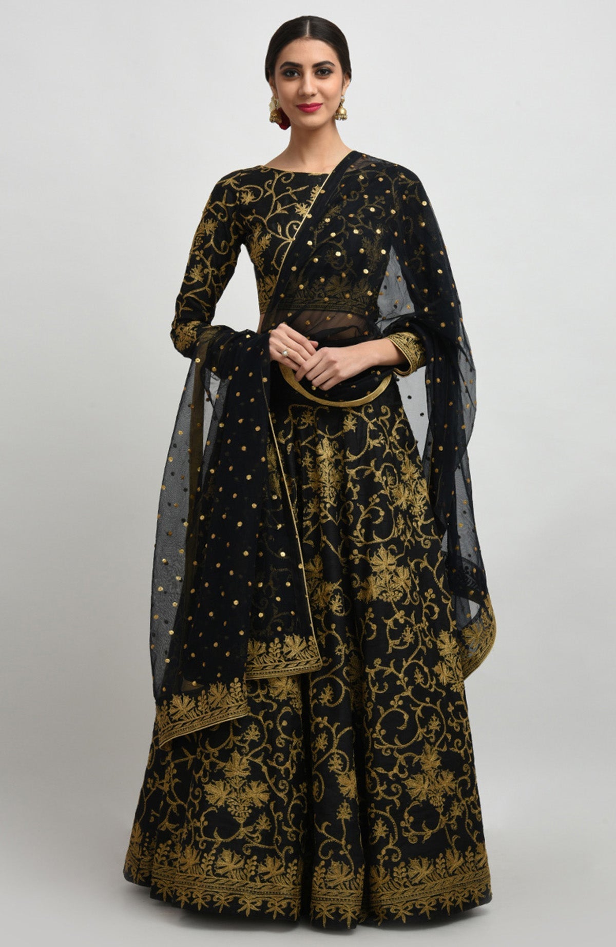 Black raw silk lehenga set with gold Kashmiri tilla aari embroidery and net dupatta.