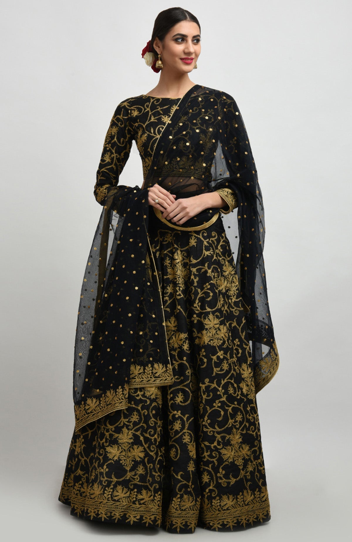 Black raw silk lehenga set with gold Kashmiri tilla aari embroidery and net dupatta.