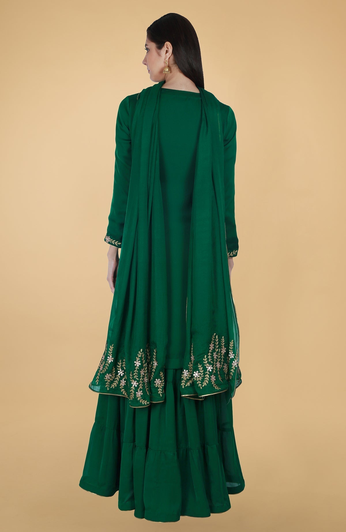Emerald green satin chiffon gharara suit with gold gota patti floral embroidery and piping details