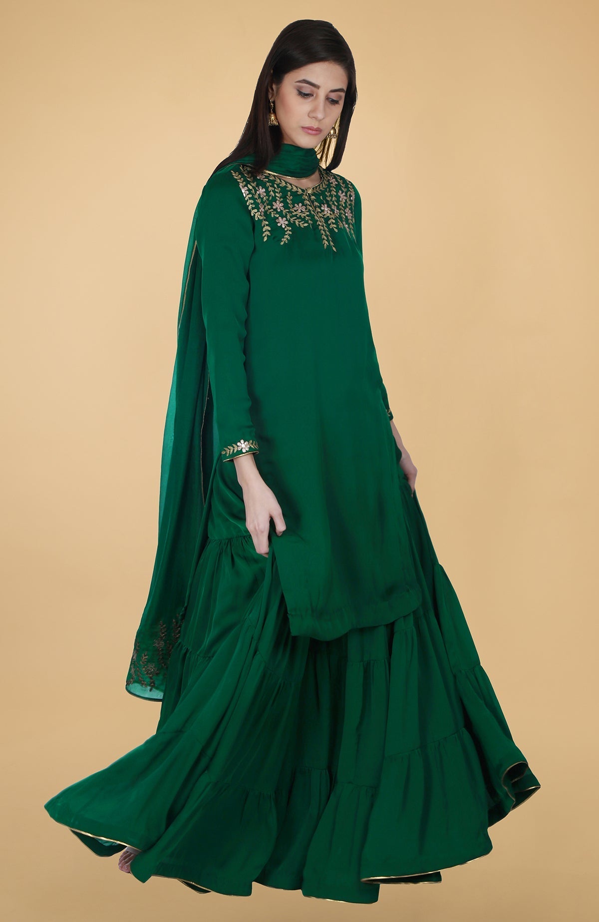 Emerald green satin chiffon gharara suit with gold gota patti floral embroidery and piping details