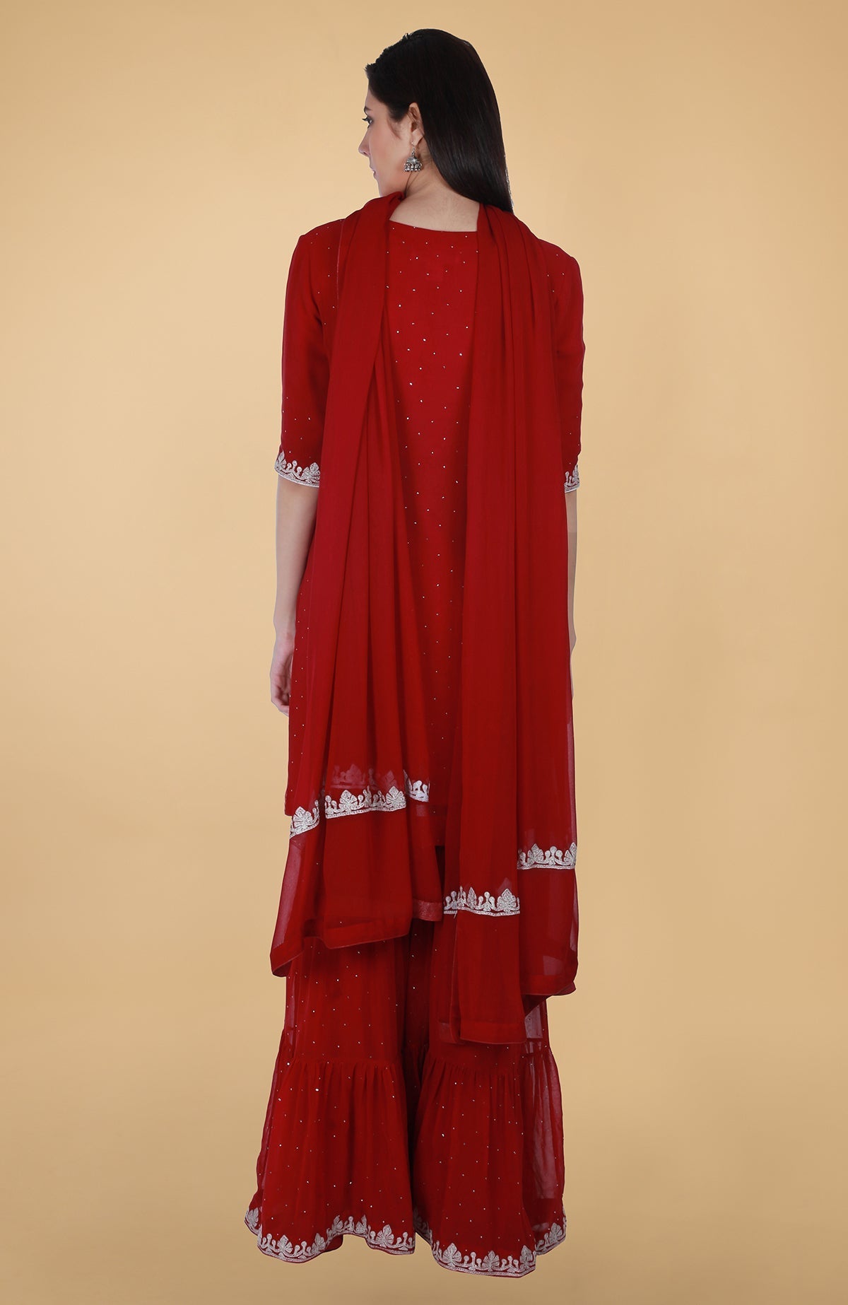 Scarlet red georgette gharara suit with silver tilla and mukaish embroidery and straight kurta.