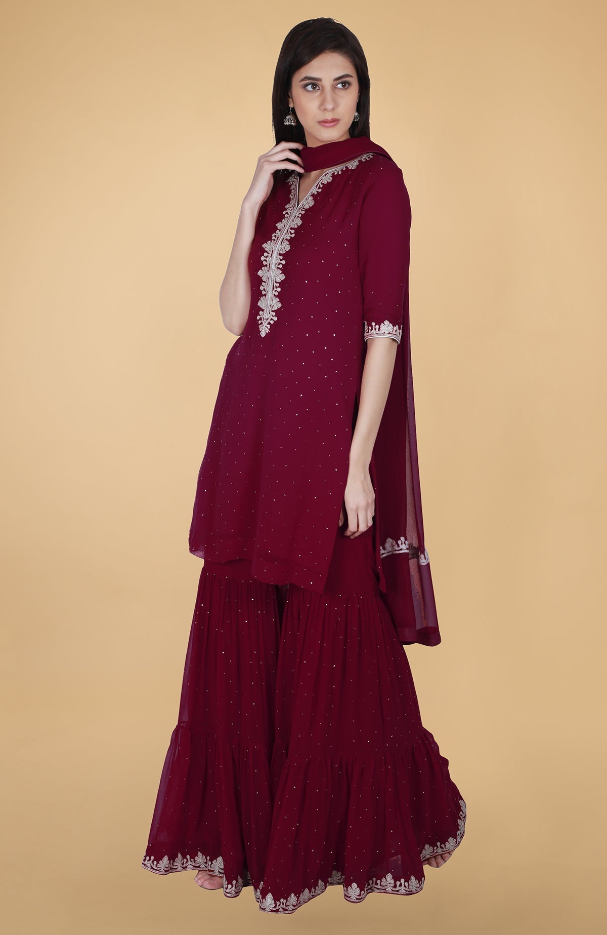 Burgundy georgette gharara suit with silver tilla and mukaish embroidery and straight kurta.