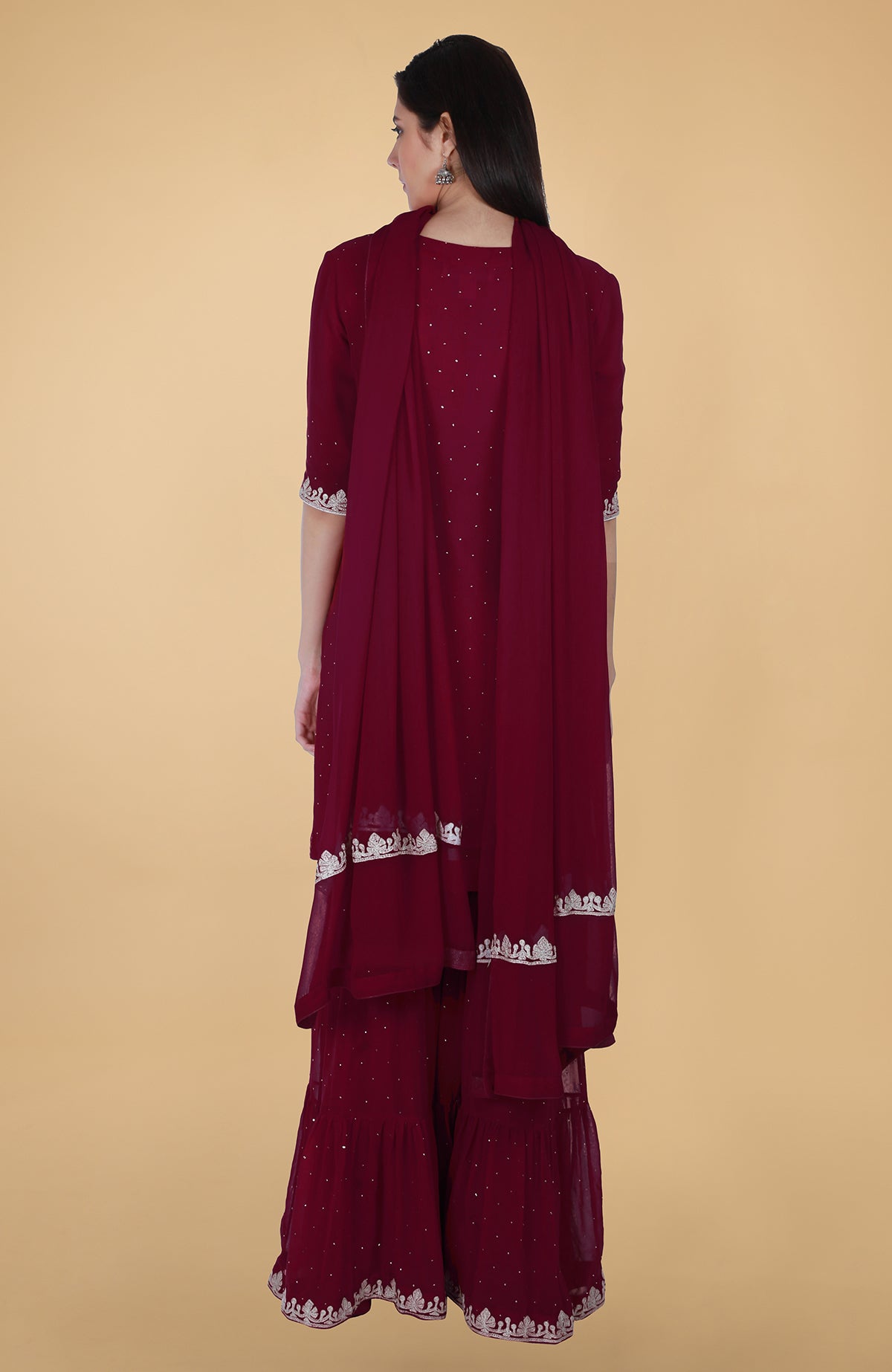 Burgundy georgette gharara suit with silver tilla and mukaish embroidery and straight kurta.