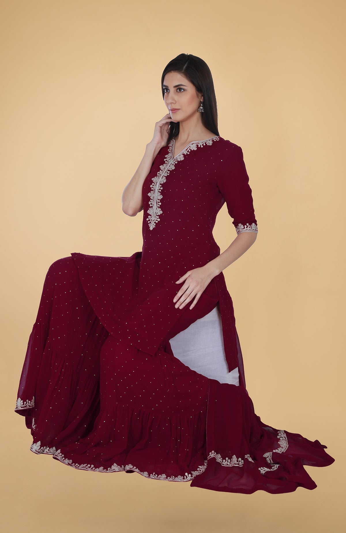 Burgundy georgette gharara suit with silver tilla and mukaish embroidery and straight kurta.