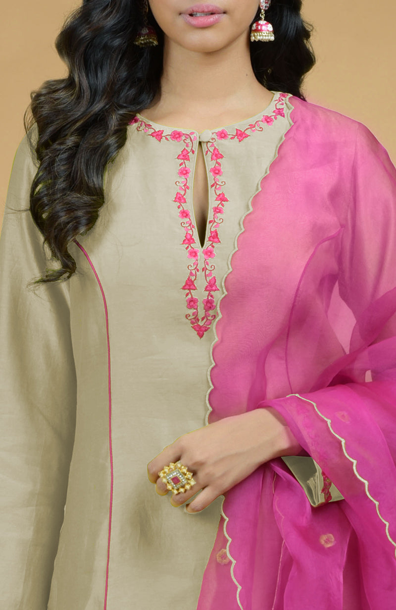 Beige kurta with pink embroidery and a magenta organza dupatta.
