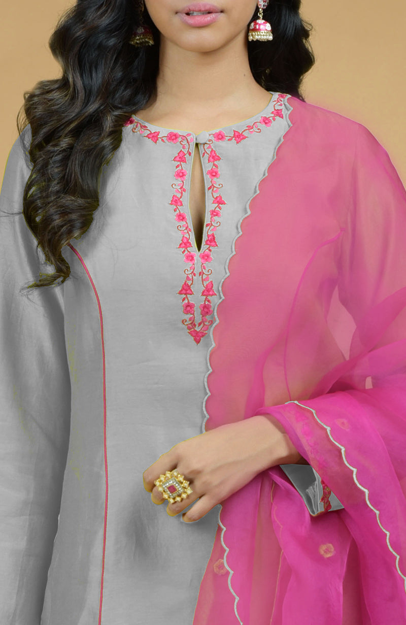 Ash grey kurta set with magenta embroidery, dupatta, and a ring.
