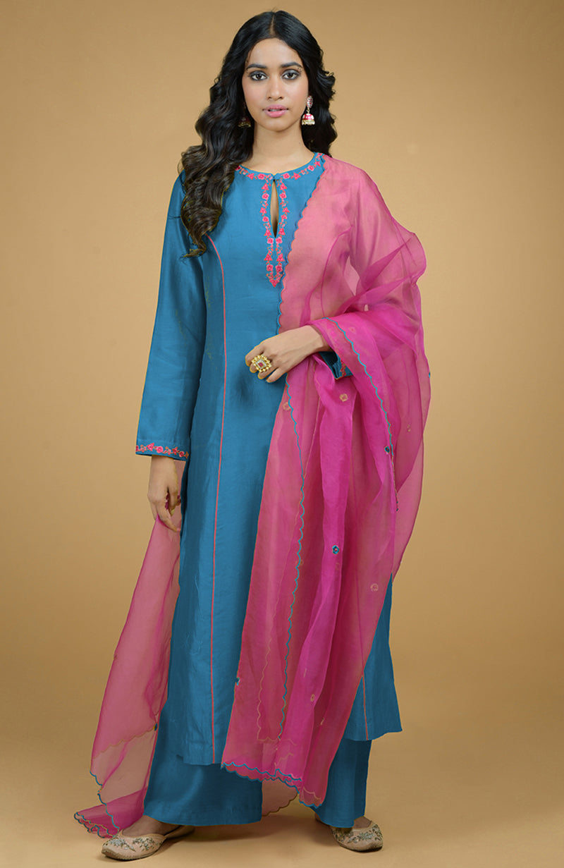 Blue kurta set with magenta organza dupatta, featuring embroidery and piping details.