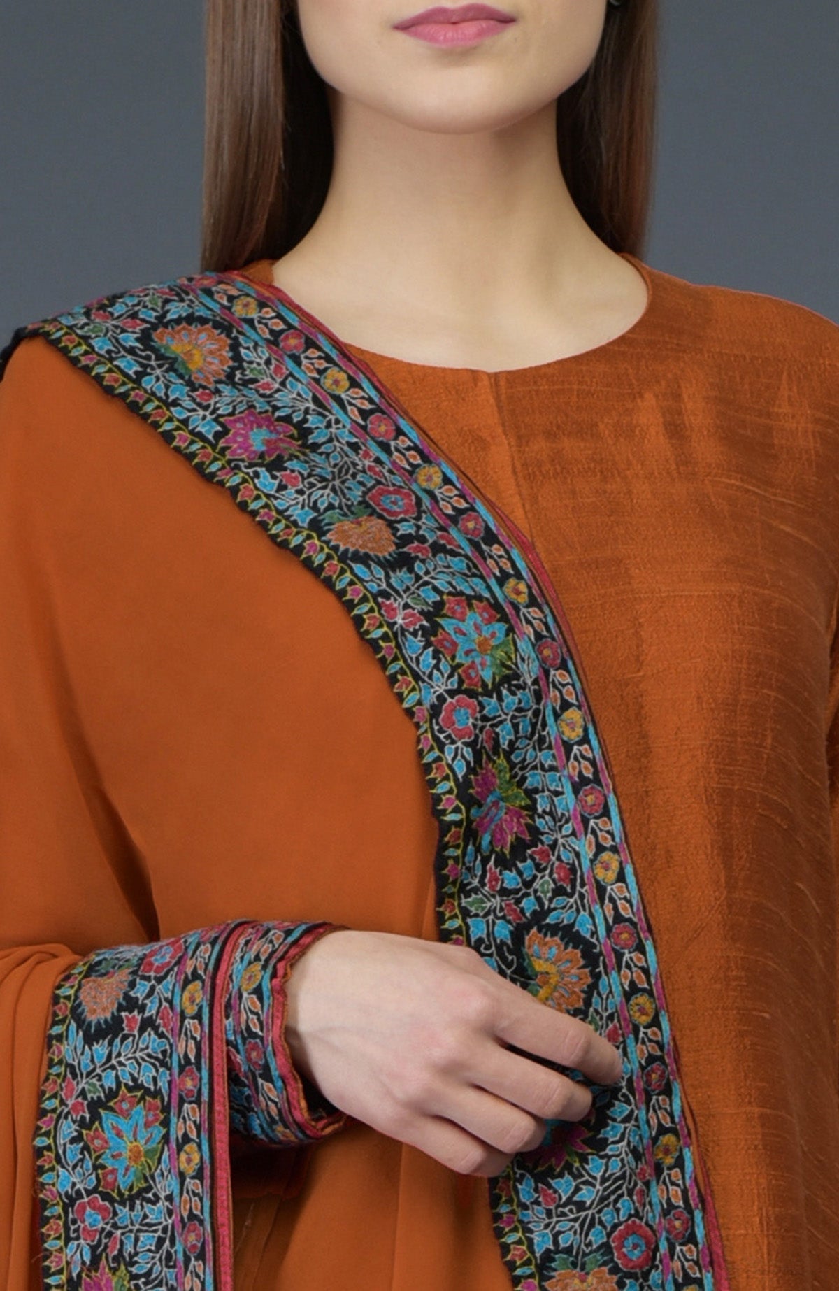 Burnt orange raw silk suit with jewel neckline and multicolor Kashmiri hand embroidery on shirt and dupatta borders