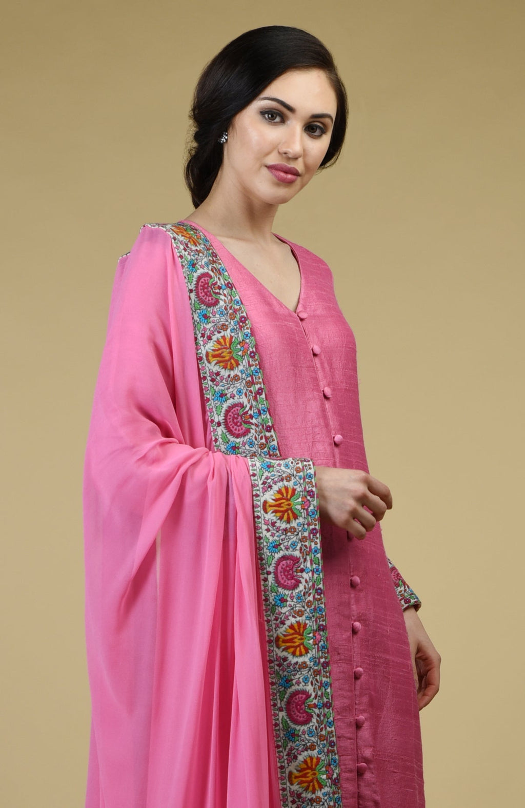 Carnation pink raw silk suit with Kashmiri Kashidakari embroidery and georgette dupatta borders.