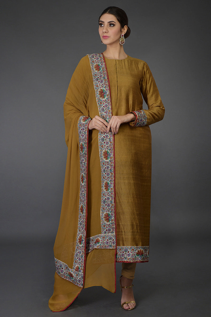 Dark mustard raw silk suit with colorful Kashmiri hand embroidery and georgette dupatta borders.