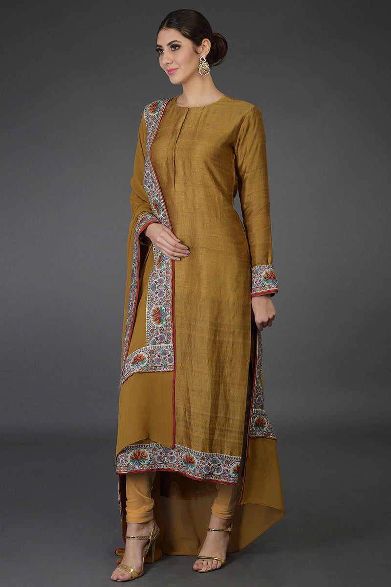 Dark mustard raw silk suit with multicolor Kashmiri hand embroidery and georgette dupatta borders.