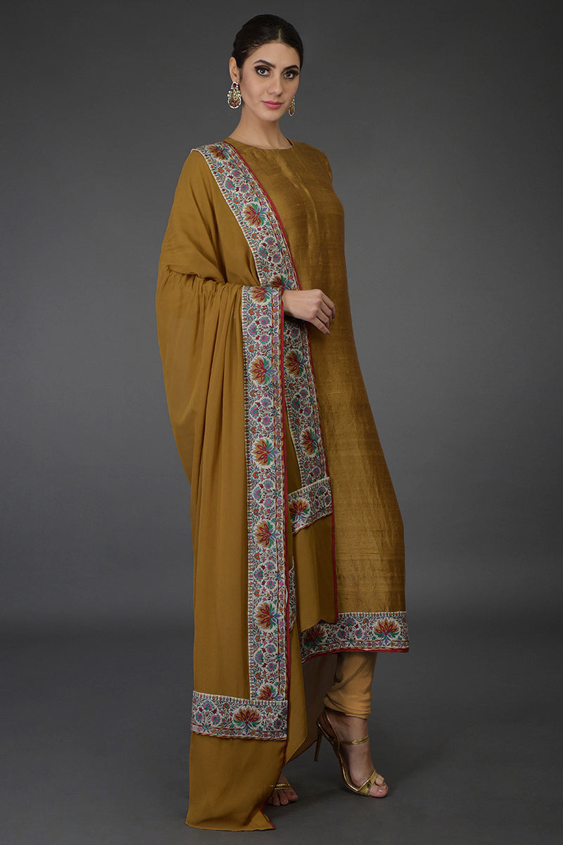 Dark mustard raw silk suit with multicolor Kashmiri hand embroidery and jewel neckline.